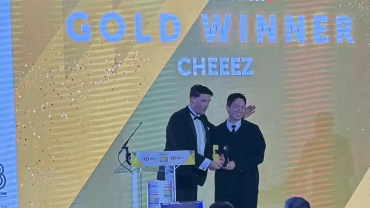 CHEEEZ team on stage receiving the Best New Business Gold award