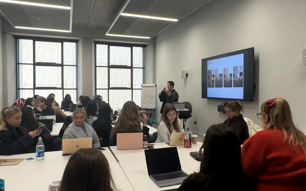 Students in a lecture room listening to Jack Lee