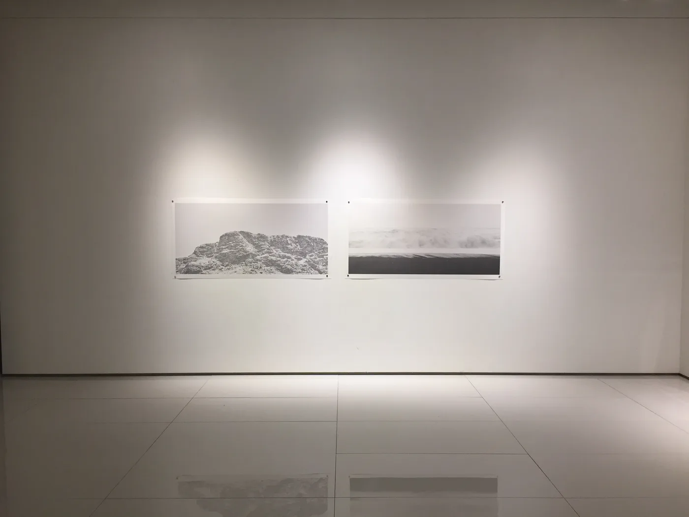 Two landscape prints on a white gallery wall, Plato's Cave